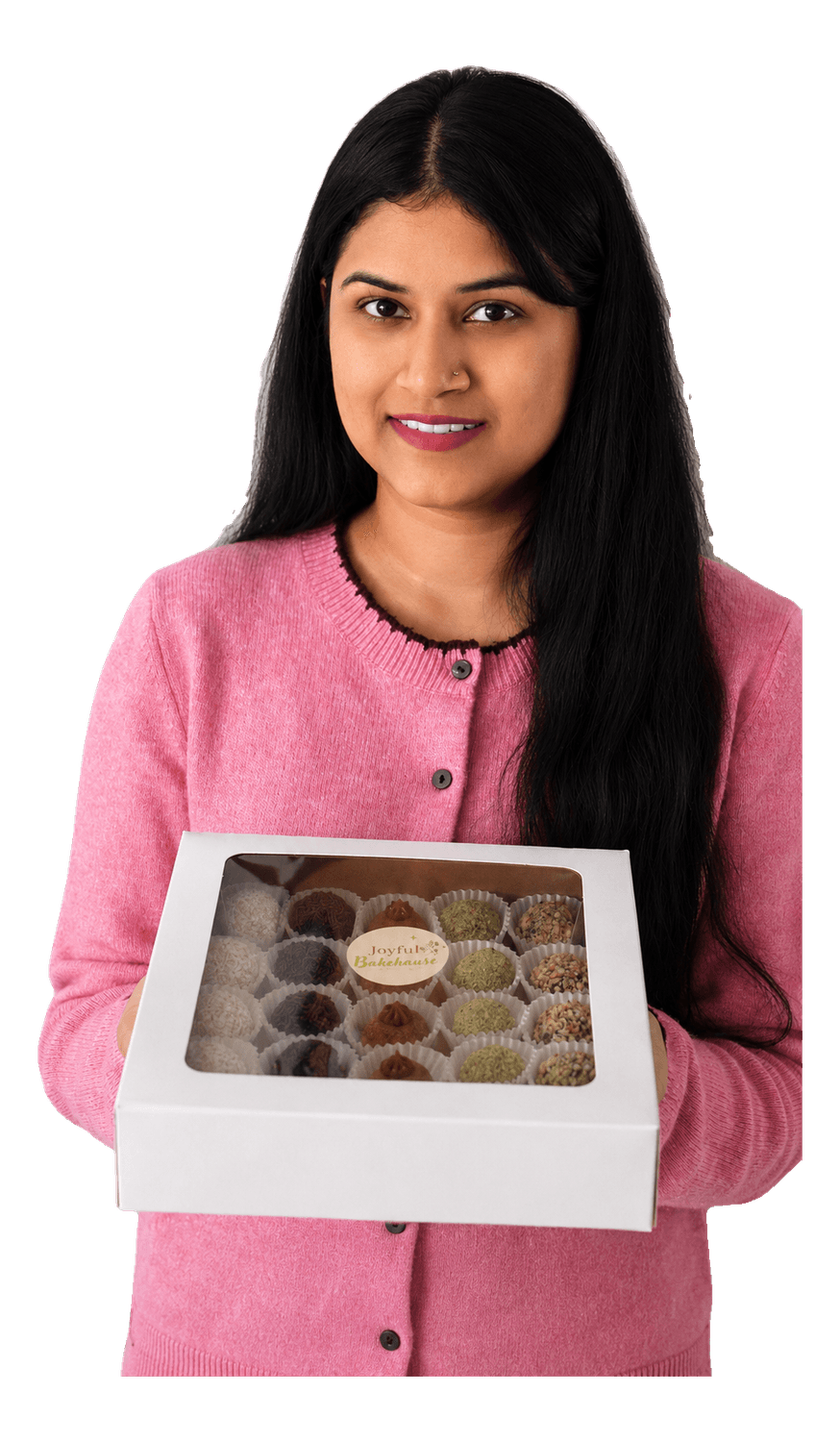 The founder of Joyful Bakehouse holding a box of handmade brigadeiros