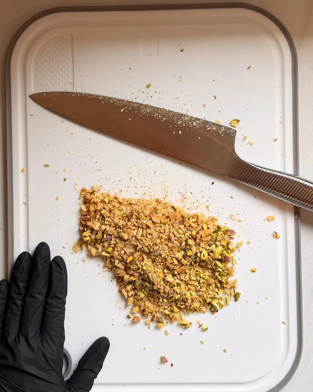 Pistachios being finely chopped during preparation